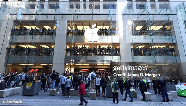 Staff celebrate the first customers at the Australian release of the latest iPhone models at the Apple Store on September 21, 2018 in Sydney,...