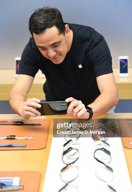 An Apple staff member photographs the new watch models at the Australian release of the latest iPhone and watches at the Apple Store on September 21,...