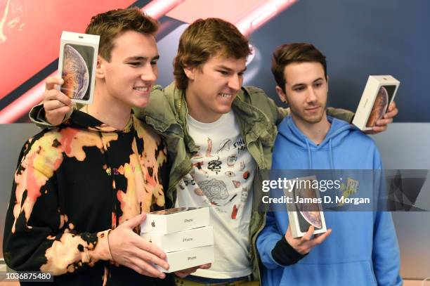 Three customers celebrate their new purchase at the Australian release of the latest iPhone models at the Apple Store on September 21, 2018 in...