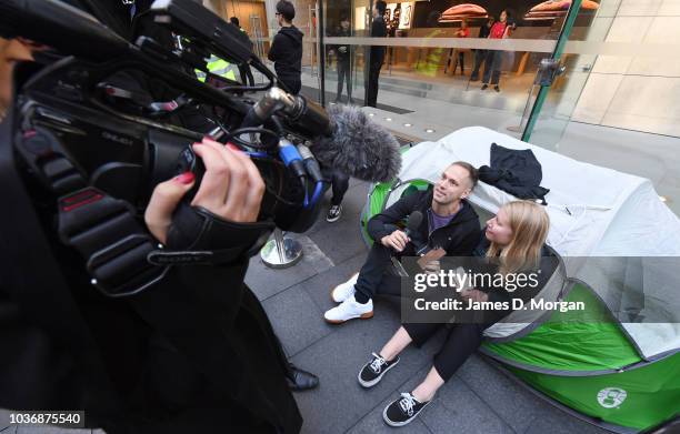 A member of the media interviews customers in line at the Australian release of the latest iPhone models at the Apple Store on September 21, 2018 in...