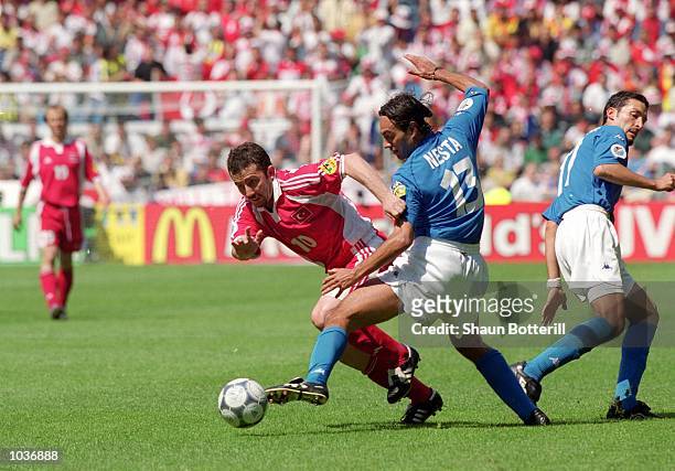 Sergen Yalcin of Turkey is challenged by Alessandro Nesta of Italy during the European Championships 2000 group match at the Gelredome in Arnhem,...