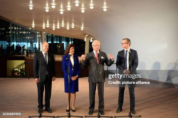 Hamburg's First Mayor Olaf Scholz , King Carl Gustav and Queen Silvia of Sweden, and Swedish Minister of Enterprise and Innovation Mikael Damberg...