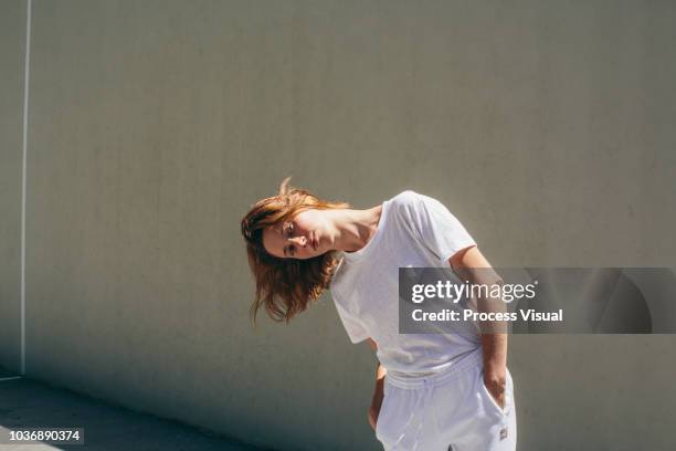 portrait of young woman in athletic attire in handball court - draft portraits stockfoto's en -beelden