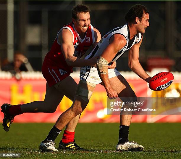 Ryan Cook of Collingwood is pressured by his opponent during the VFL second Elimination Final match between the Northern Bullants and Collingwood at...