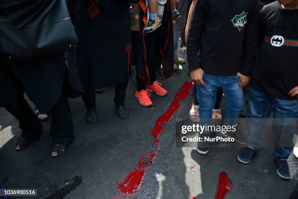 Shiite Muslim men, standing in the blood of a ritually slaughtered sheep, on Ashura Day, in Tehran,iran, 20 sept , 2018. Ashoura is the annual Shiite...