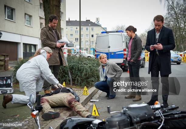 Coroner Greta Leitner and commissars Peter Faber , Martina Bönisch , Nora Dalay and Daniel Kossik , pictured around the corpse of a rocker, pictured...