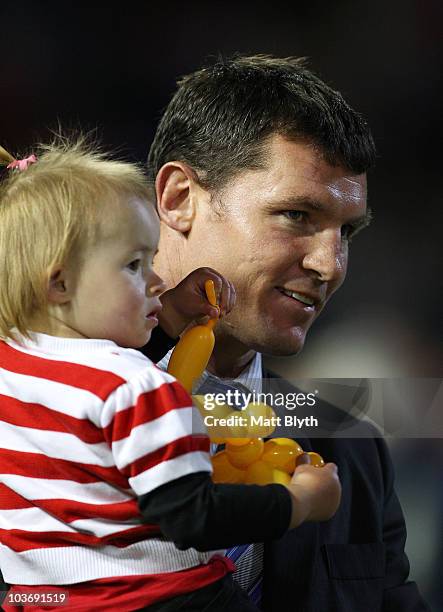 Steve Simpson of the Knights looks on with his daughter before the round 25 NRL match between the Newcastle Knights and the St George Illawarra...