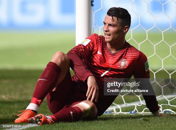 Cristiano Ronaldo of Portugal sits on the pitch during the FIFA World Cup 2014 group G preliminary round match between Portugal and Ghana at the...