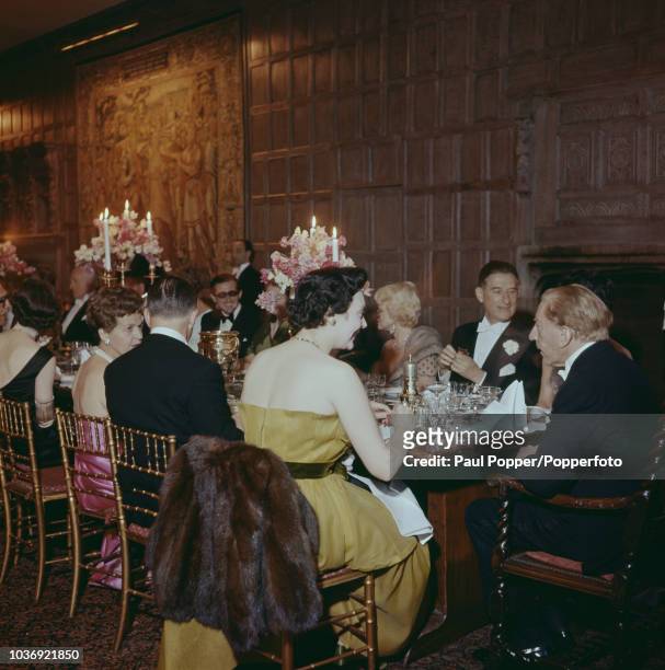 American born industrialist J Paul Getty with his guests at a party at his recently acquired Sutton Place manor house near Guildford, Surrey, 7th...