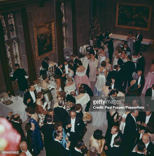 American born industrialist J Paul Getty among his guests at a party at his recently acquired Sutton Place manor house near Guildford, Surrey, 7th...
