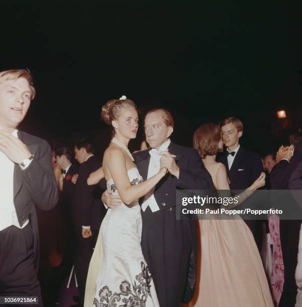 American born industrialist J Paul Getty dancing with French model Madelle Hegeler at a party at his recently acquired Sutton Place manor house near...