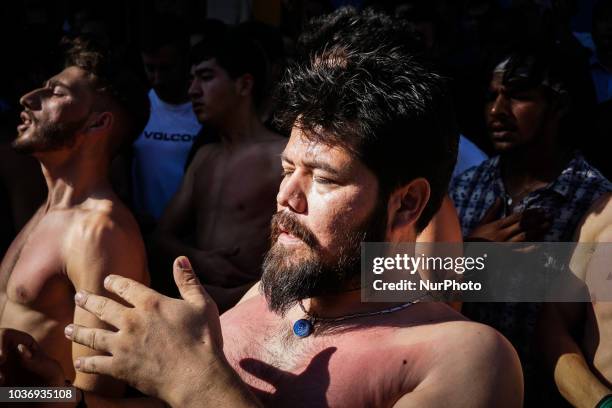 Shiite Muslims perform during the annual commemoration Ashura in Pireaus , 20 September 2018. Hundreds of Shiite Muslims gathered in Piraeus to...