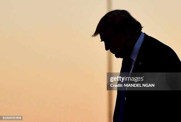 President Donald Trump steps off Air Force One upon arrival at McCarran International Airport in Las Vegas on September 20, 2018. - Trump is heading...