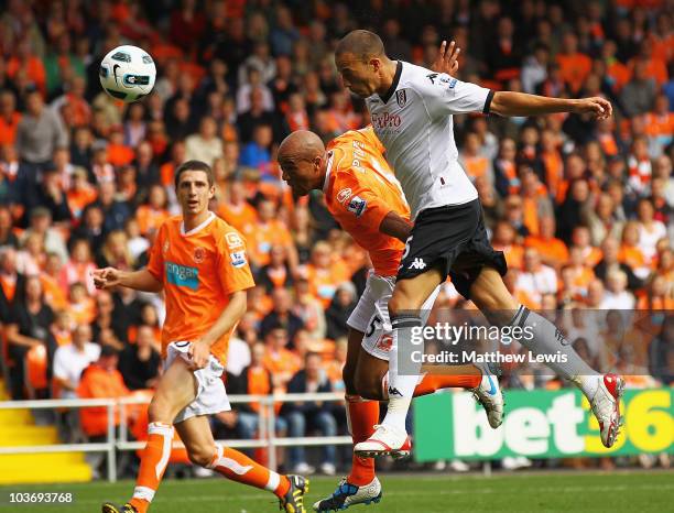 Bobby Zamora of Fulham beats Alex Baptiste of Blackpool to score a goal during the Barclays Premier League match between Blackpool and Fulham at...