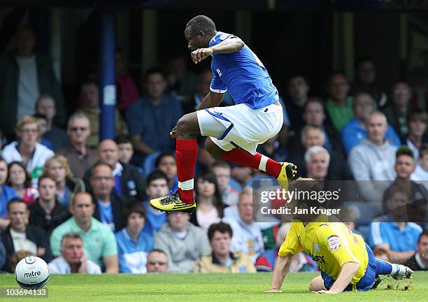 John Utaka of Portsmouth leaps over the tackle of Lee Naylor of Cardiff City during the npower Championship match between Portsmouth and Cardiff City...