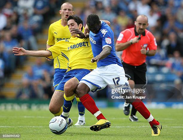 John Utaka of Portsmouth holds off Peter Whittingham of Cardiff City during the npower Championship match between Portsmouth and Cardiff City at...