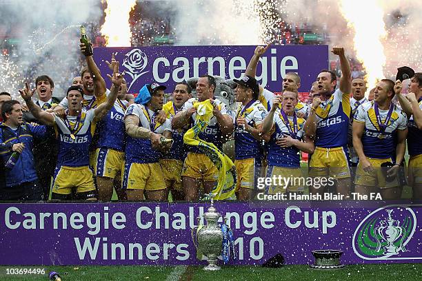 The Warrington team celebrate with the trophy after the Challenge Cup Final between Leeds Rhinos and Warrington Wolves at Wembley Stadium on August...