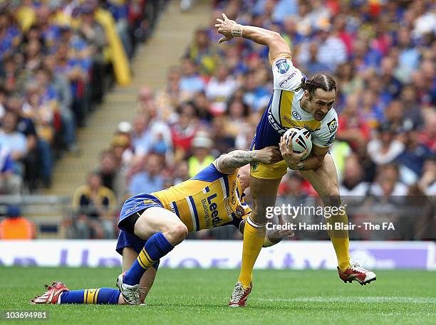 Vinnie Anderson of Warrington is tackled by Brett Delaney of Leeds during the Challenge Cup Final between Leeds Rhinos and Warrington Wolves at...