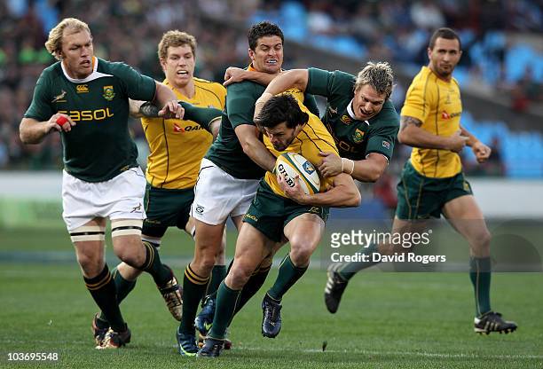Adam Ashley-Cooper of the Wallabies is tackled by Jean de Villiers and Morne Steyn during the 2010 Tri-Nations match between the South African...