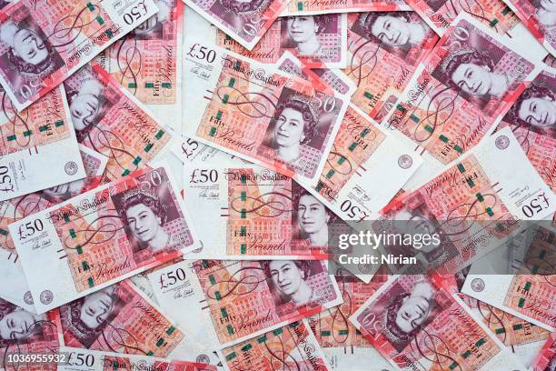 spread of random 50 british pound notes - uk cash stock pictures, royalty-free photos & images