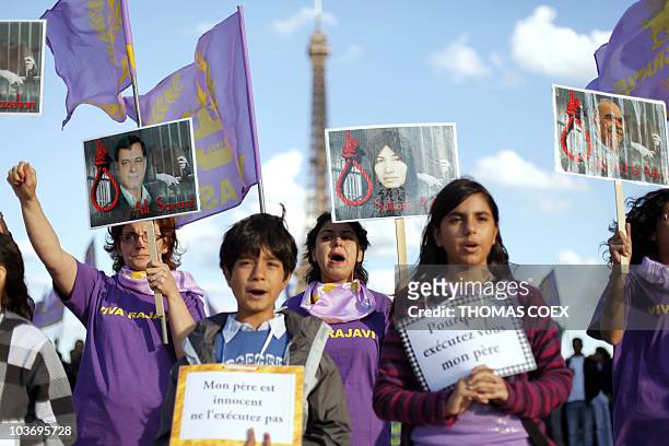People take part in a demonstration on August 28, 2010 in front of the Eiffel tower at the Trocadero esplanade in Paris, in support to Sakineh...
