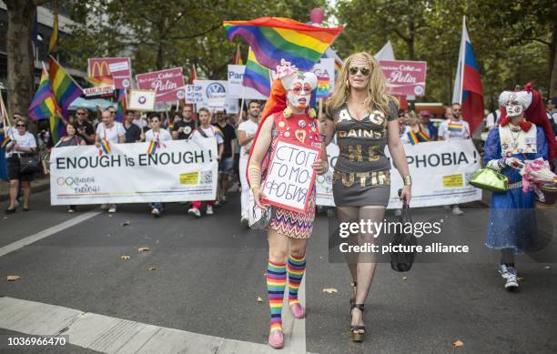 Demonstrators walk down Kurfuerstendamm and protest against Russia's new anti-gay propaganda law with posters and signs in Berlin, Germany, 31 August...