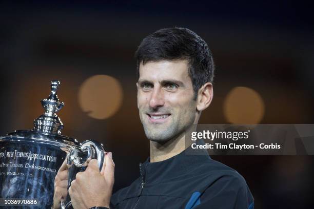 Open Tennis Tournament- Day Fourteen. Novak Djokovic of Serbia celebrates with the trophy after his victory against Juan Martin Del Potro of...