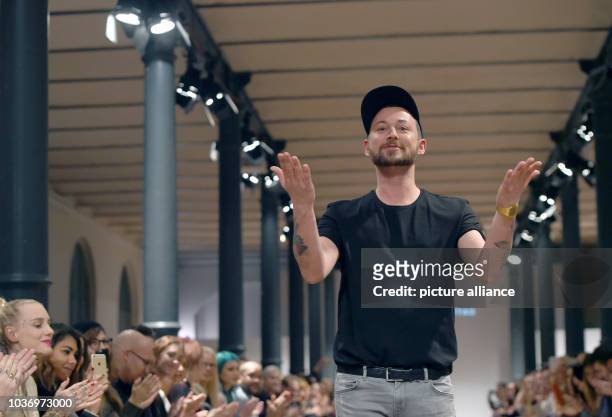 Designer Marcel Ostertag walks on the catwalk during a presentation of his fashion label Marcel Ostertag during the Berlin Fashion Week, Berlin,...