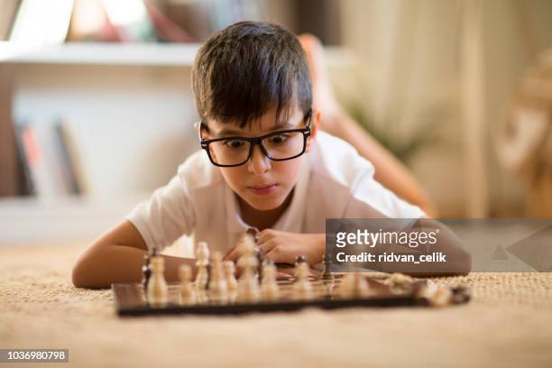 little boy playing chess - chess defeat stock pictures, royalty-free photos & images