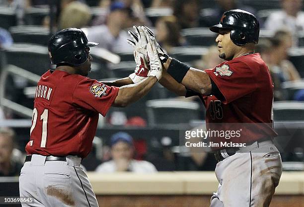 Carlos Lee of the Houston Astros celebrates his fifth inning two run home run against the New York Mets with teammate Michael Bourn on August 28,...