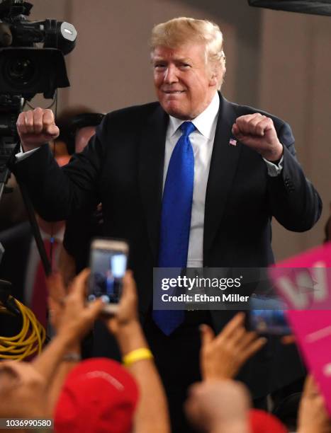 President Donald Trump reacts to the crowd after being interviewed by Fox News Channel and radio talk show host Sean Hannity before a campaign rally...