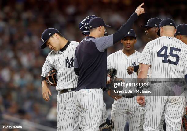 Masahiro Tanaka of the New York Yankees is removed from a game against the Boston Red Sox during the fifth inning by manager Aaron Boone at Yankee...