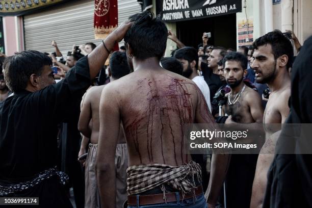 Shia Muslim mourner seen flagellated during the Ashura commemoration when Shia Muslims mourn the slaying of the Prophet Mohammed's grandson Imam...