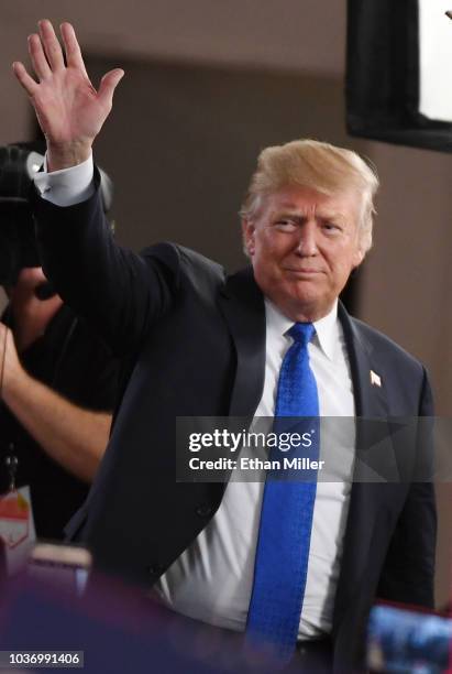 President Donald Trump waves after being interviewed by Fox News Channel and radio talk show host Sean Hannity before a campaign rally at the Las...