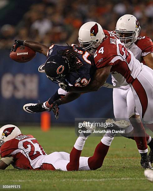 Devin Hester of the Chicago Bears is upended by Adrian Wilson of the Arizona Cardinals during a preseason game at Soldier Field on August 28, 2010 in...