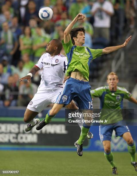 Collins John of the Chicago Fire heads the ball against Alvaro Fernandez of the Seattle Sounders FC on August 28, 2010 at Qwest Field in Seattle,...