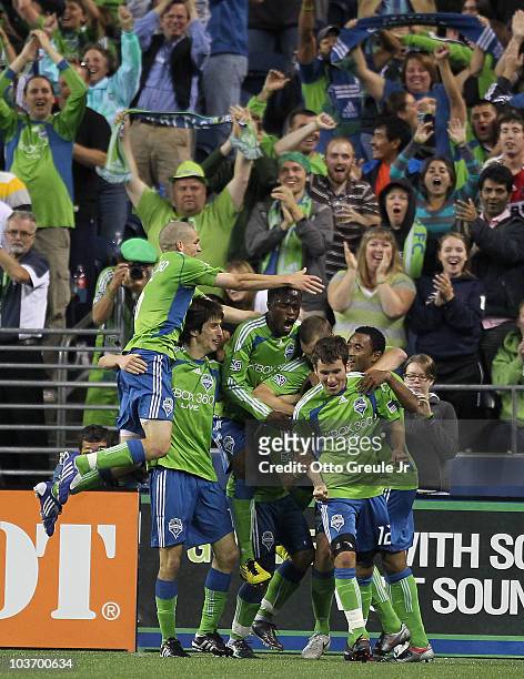 Members of the Seattle Sounders FC celebrate after Fredy Montero scored the winning goal to defeat the Chicago Fire 2-1 on August 28, 2010 at Qwest...
