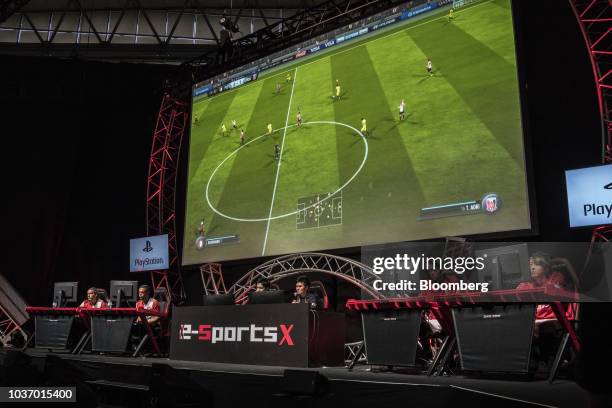 Japanese video-game players, right, and Dutch players, left, play an online football game on the e-sports X stage during a media preview day at the...