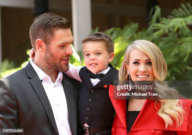 Carrie Underwood with her husband, Mike Fisher and their son, Isaiah Michael Fisher attend the ceremony honoring Carrie Underwood with a Star on The...