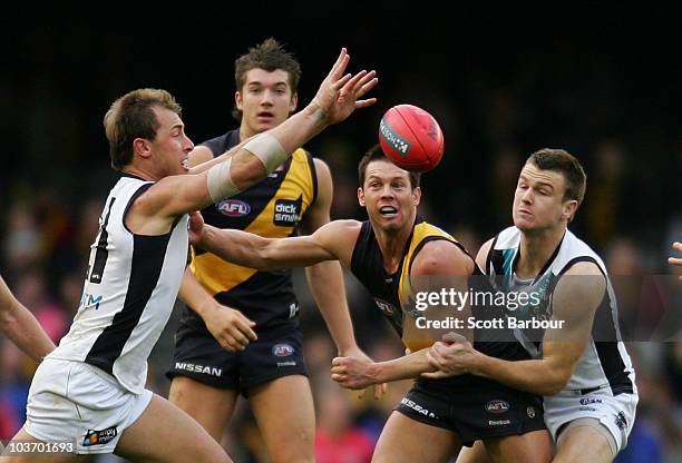 Ben Cousins of the Tigers passes the ball during the round 22 AFL match between the Richmond Tigers and the Port Power at Etihad Stadium on August...