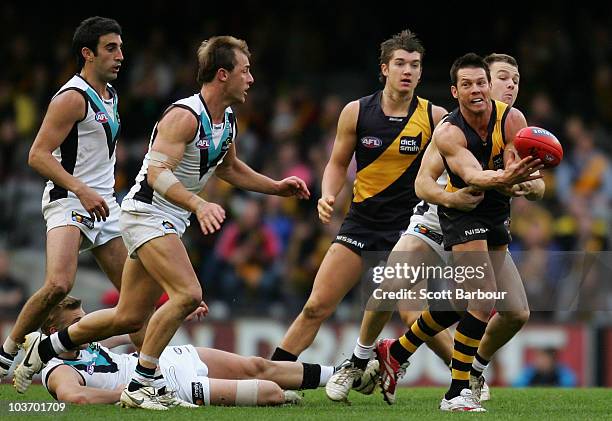 Ben Cousins of the Tigers passes the ball during the round 22 AFL match between the Richmond Tigers and the Port Power at Etihad Stadium on August...