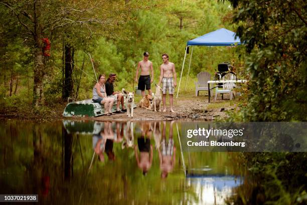 Residents with dogs wait for groceries to be delivered by volunteers after Hurricane Florence hit in Bergaw, North Carolina, U.S., on Thursday, Sept....