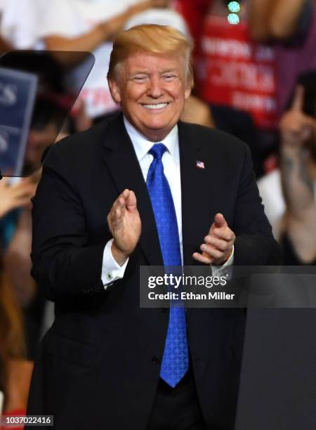 President Donald Trump smiles as he walks onstage for a campaign rally at the Las Vegas Convention Center on September 20, 2018 in Las Vegas, Nevada....