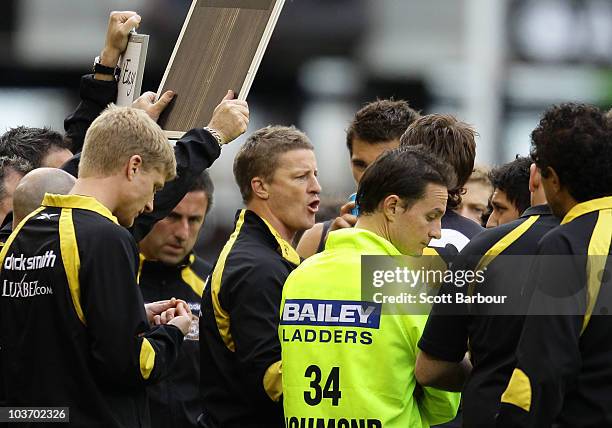 Richmond Tigers coach Damien Hardwick speaks to his players during the round 22 AFL match between the Richmond Tigers and the Port Power at Etihad...