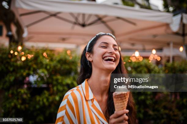 smiling woman holding icecream. - italian icecream stock pictures, royalty-free photos & images