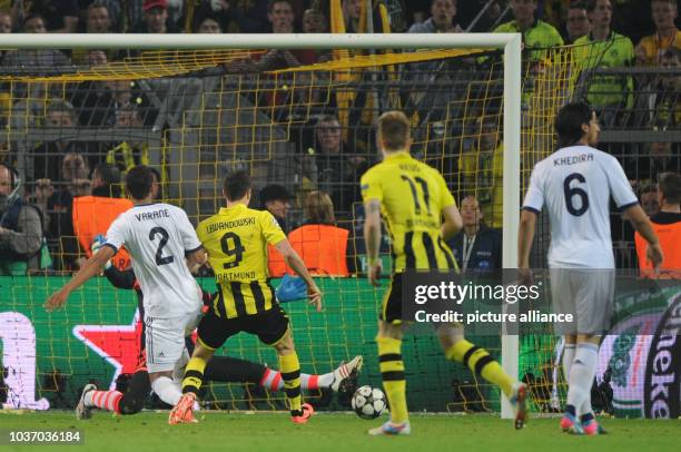 Dortmund's Robert Lewandowski scores 2-1 goal against Madrid's goalkeeper Diego Lopez and Raphael Varane during the UEFA Champions League semi final...