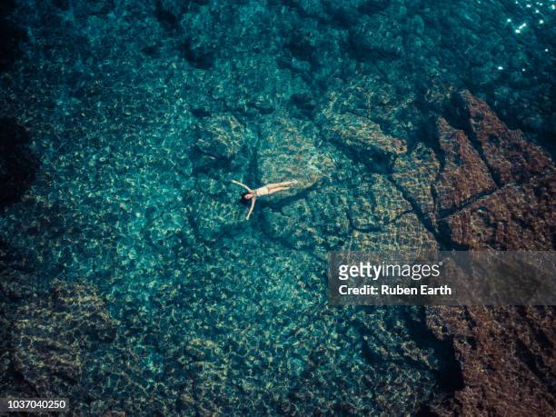 woman relaxing in mediterranean sea aerial - natación fotografías e imágenes de stock