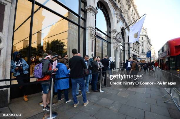 Customers queue outside the Apple Store in Regent Street, central London, as the iPhone XS and XS Max go on sale in the UK for the first time,...