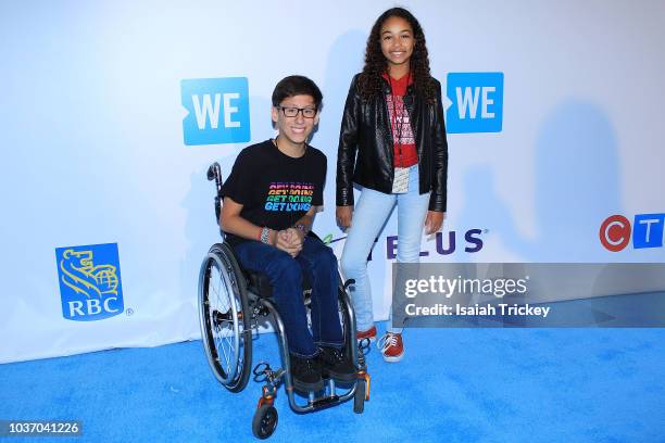 Tai Young and Millie Davis arrive at WE Day Toronto on the WE Carpet at Scotiabank Arena on September 20, 2018 in Toronto, Canada.