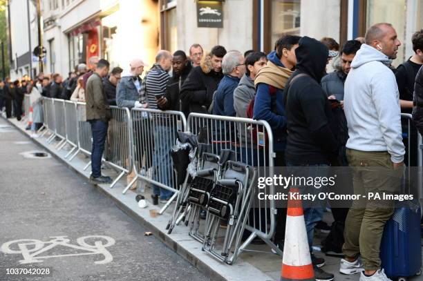 Customers queue outside the Apple Store in Regent Street, central London, as the iPhone XS and XS Max go on sale in the UK for the first time,...